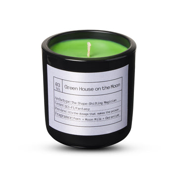 Green candle in a black container with a label on a white background FLORES LANE MOVIE GENRE CANDLES: SCI-FI MOVIE | ACADEMY MUSEUM